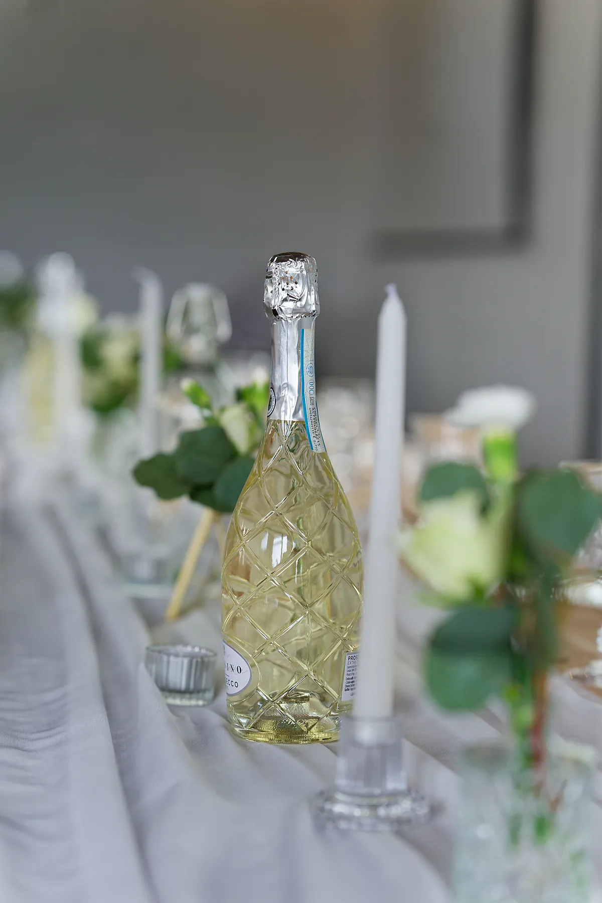 Chilled bottle of prosecco on the wedding breakfast table